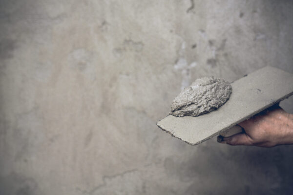 Plasterer renovating indoor walls.